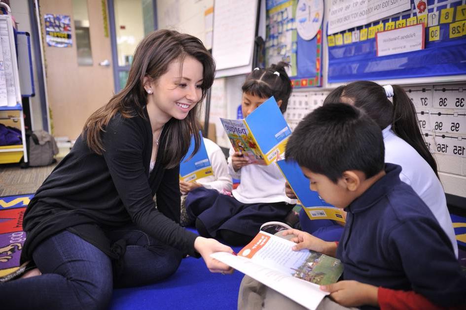 Teacher with student on floor